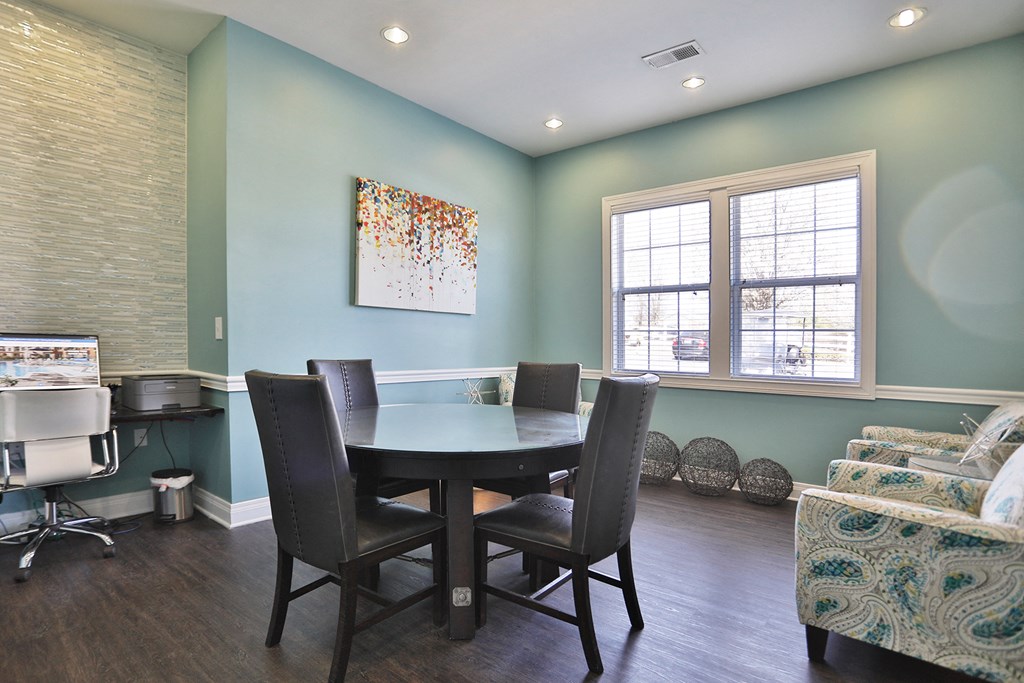 a dining room with a table and chairs and a window