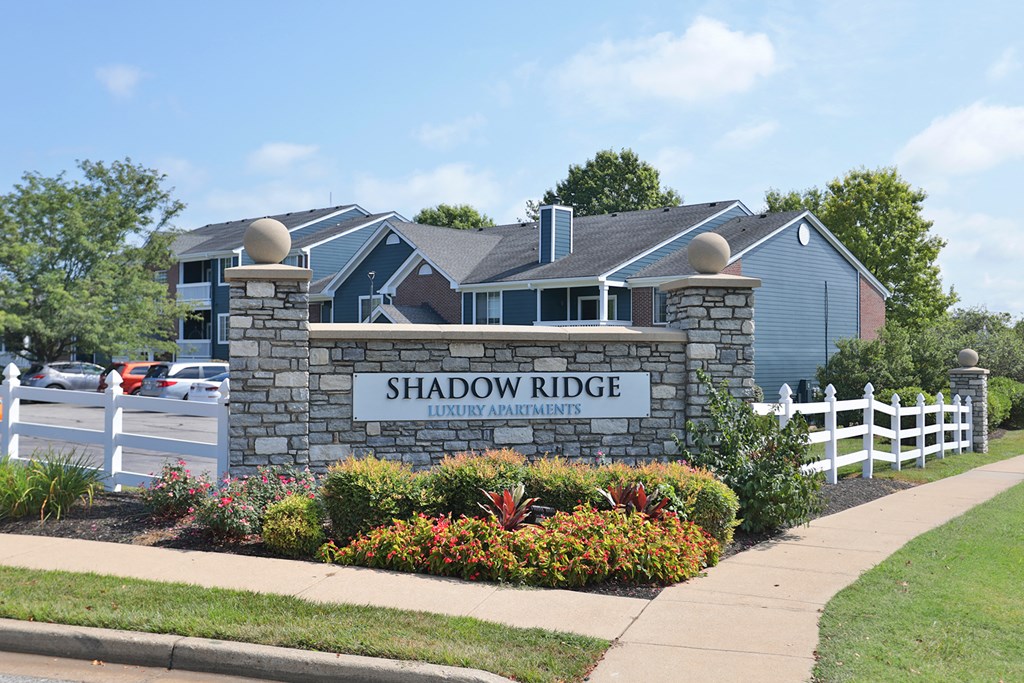 a sign for shadow ridge in front of a house