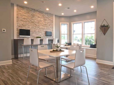a dining room with a table and chairs