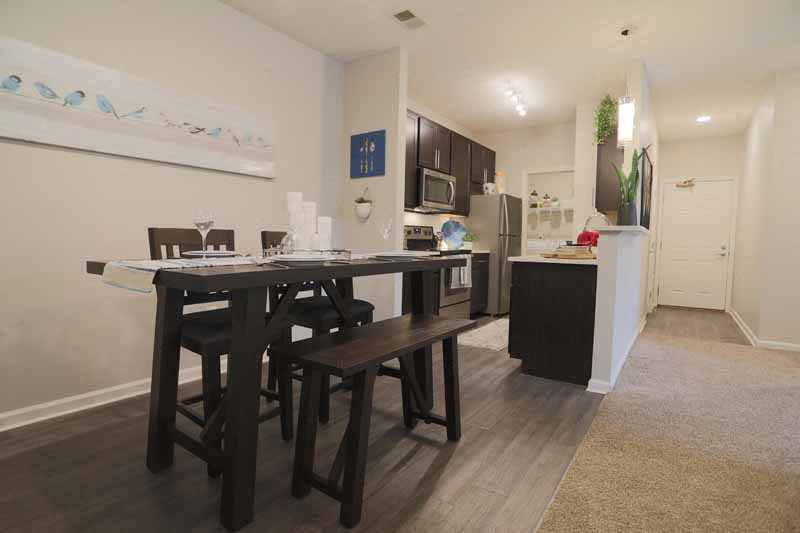 a kitchen and dining room with a table and chairs