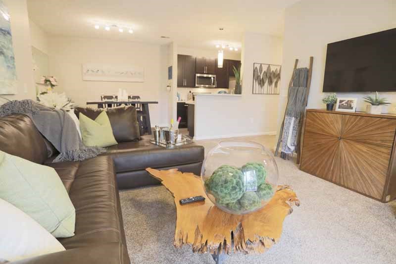 a living room with a brown leather couch and a table