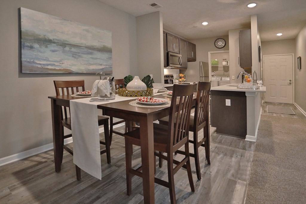 an open kitchen and dining area with a table and chairs