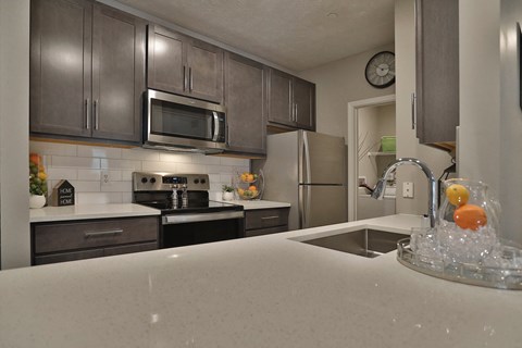 a kitchen with stainless steel appliances and a white counter top