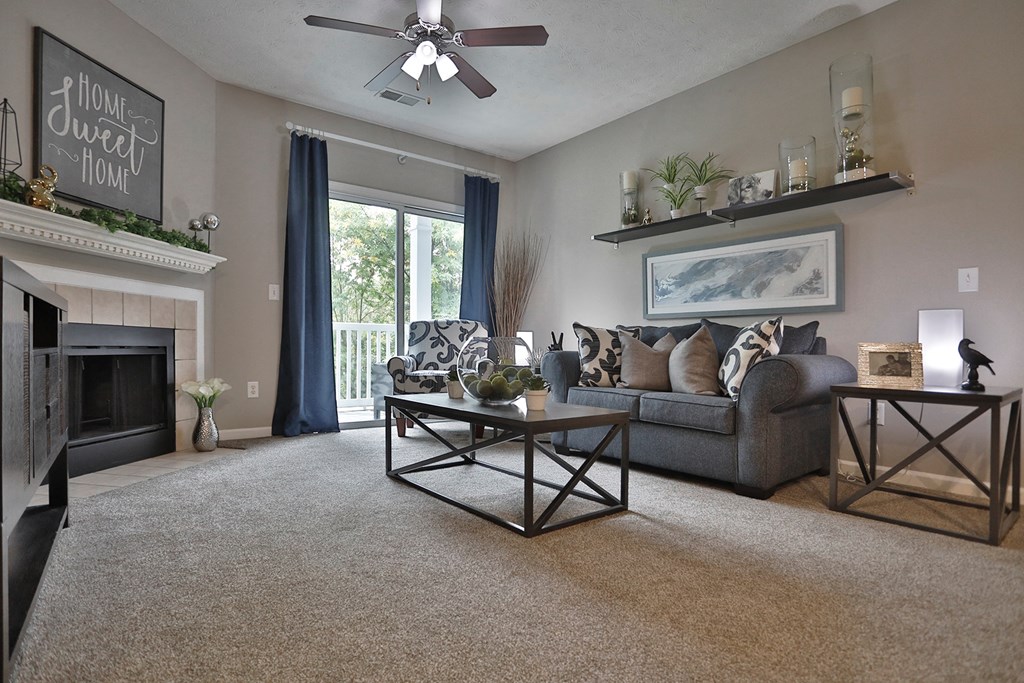 an open living room with a fireplace and a couch