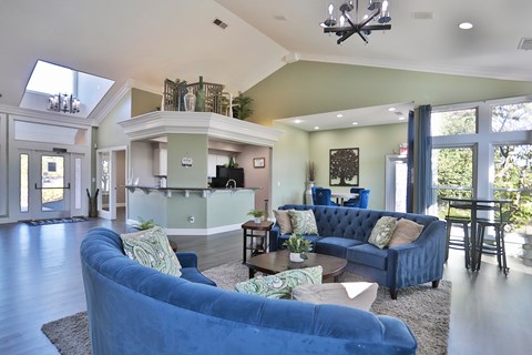 A blue couch is in the middle of a living room.