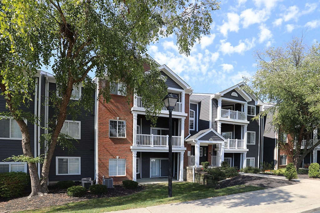 a row of apartments with balconies and trees