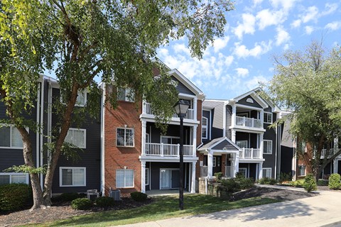 a row of apartments with balconies and trees