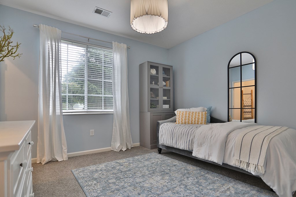 a bedroom with a bed and a window