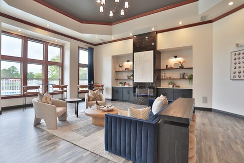 A modern living room with a dark blue sofa and a wooden floor.