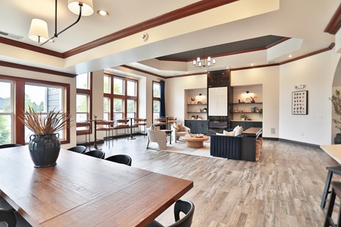 A modern dining room with a wooden table and chairs.