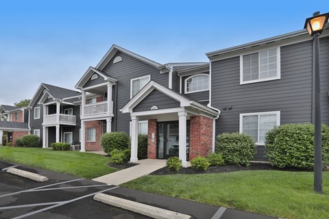 A street view of a residential area with houses and a street lamp.