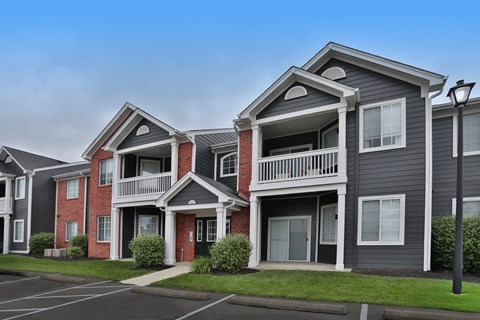 A row of townhouses with a clear sky above.