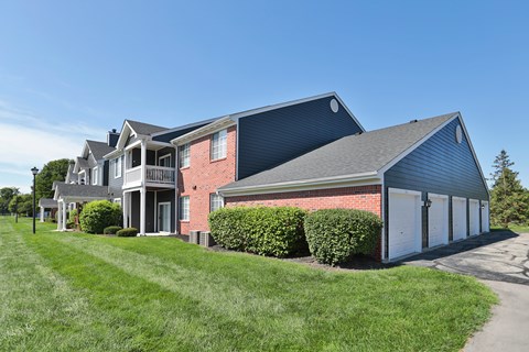 A large house with a red brick exterior and a grey roof.