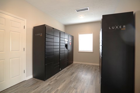 A room with a black LUXER branded wardrobe.