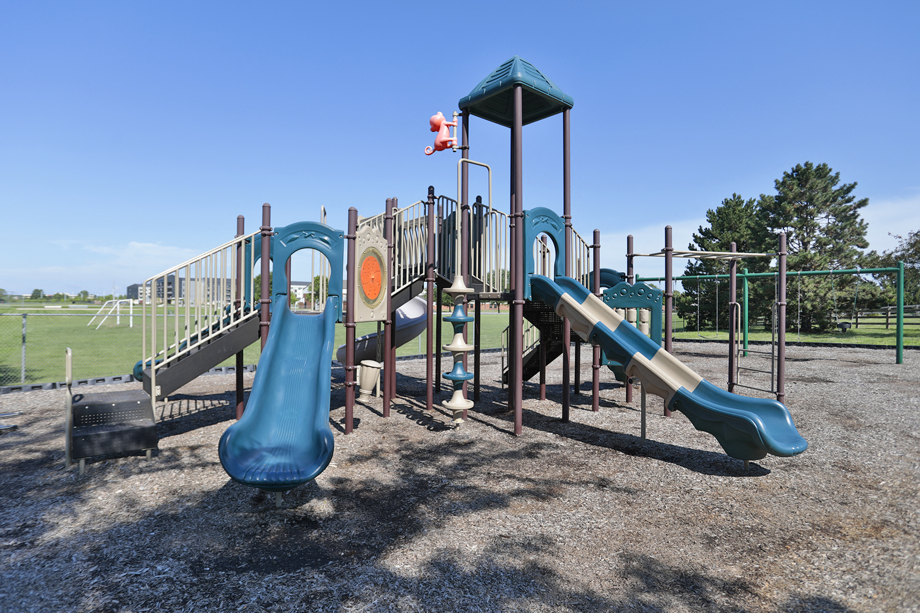 a playground with slides and other equipment in a park