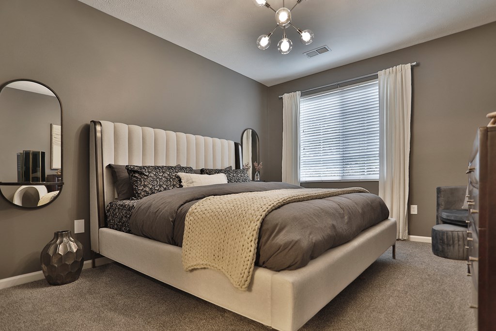 a bedroom with a bed and a dresser