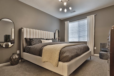 a bedroom with a bed and a dresser