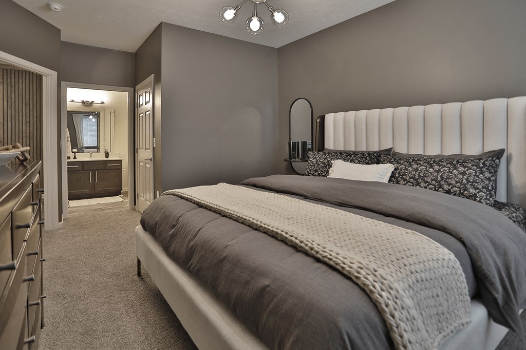 a bedroom with a bed and a bathroom