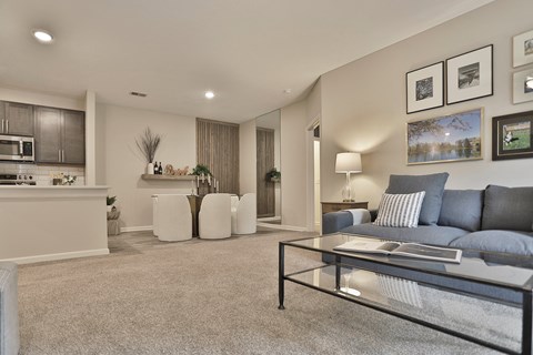 a living room with a couch and a glass table