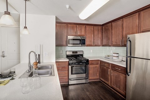 a kitchen with wooden cabinets and stainless steel appliances