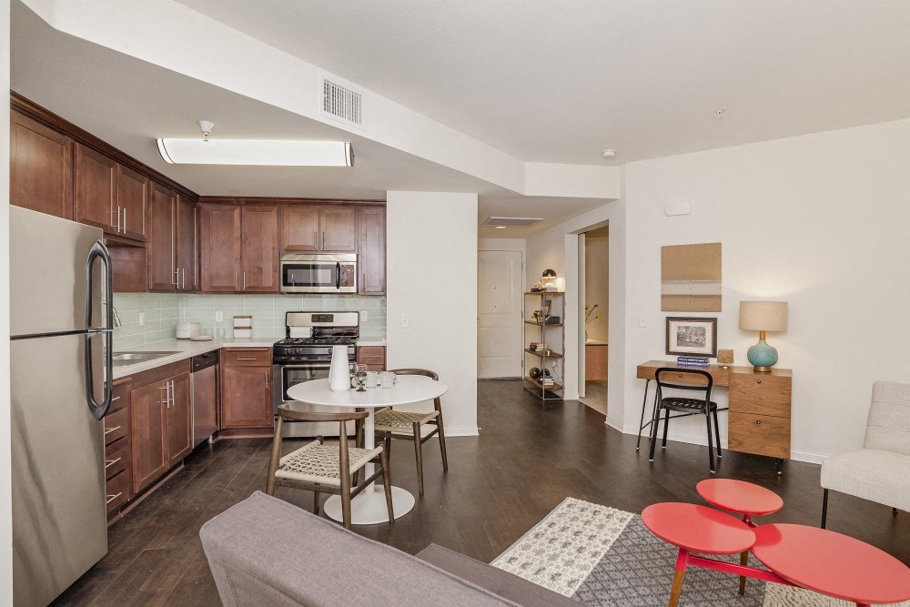a living room and kitchen with a table and chairs