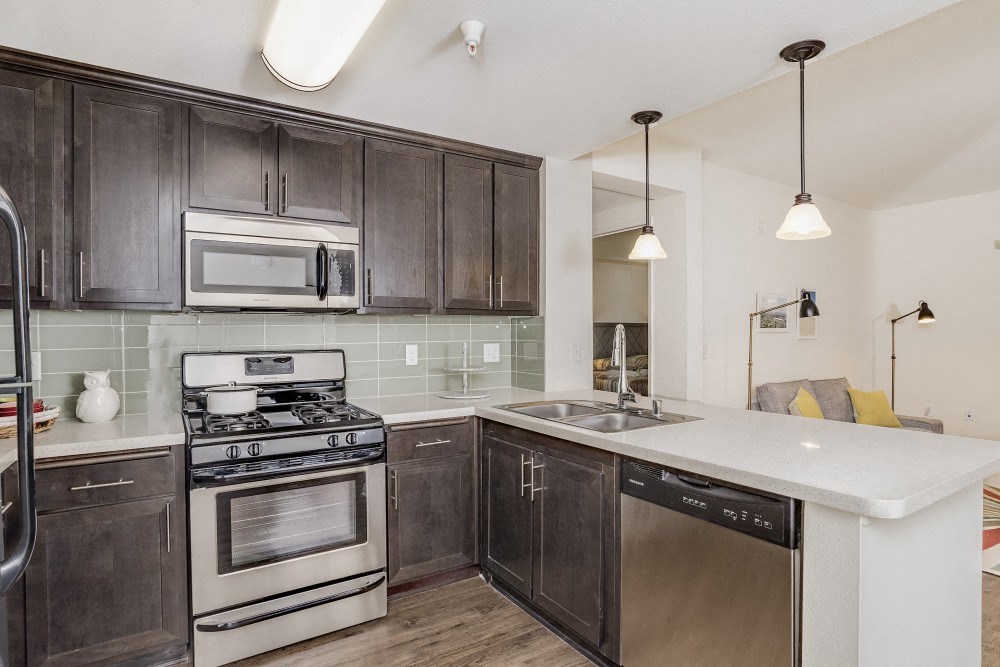 a kitchen with stainless steel appliances and wooden cabinets