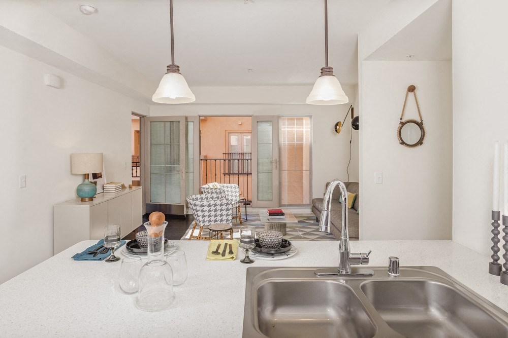 a kitchen with a sink and a view of a living room