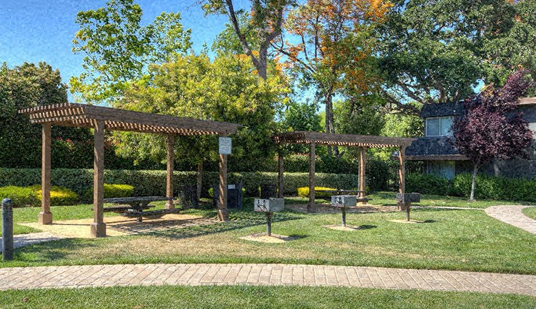 a park with benches and a picnic area