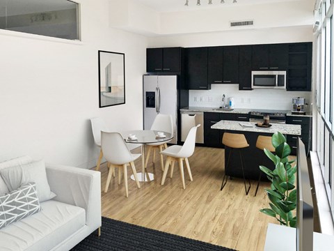 A modern kitchen with a dining table and chairs.