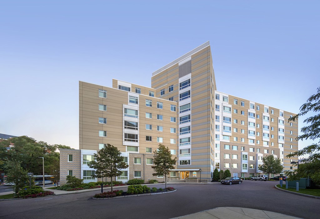 a rendering of a large apartment building at dusk