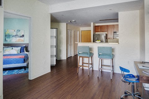 a view of a living room with a kitchen and a dining room
