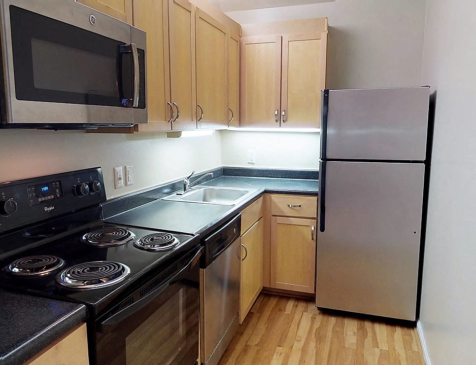a kitchen with stainless steel appliances and wooden cabinets
