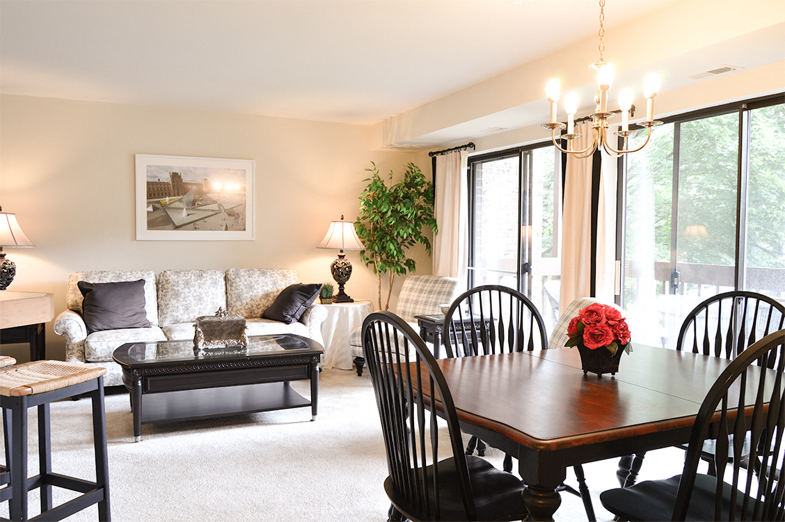 A dining room with a wooden table and chairs.
