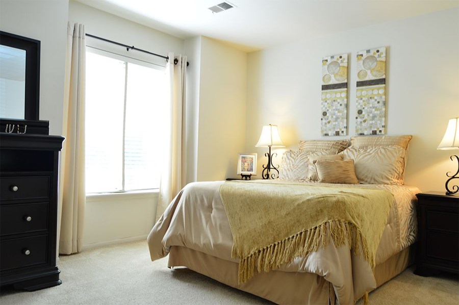 a bedroom with a bed and two windows