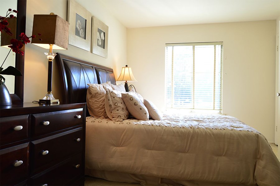 a bedroom with a bed and a dresser