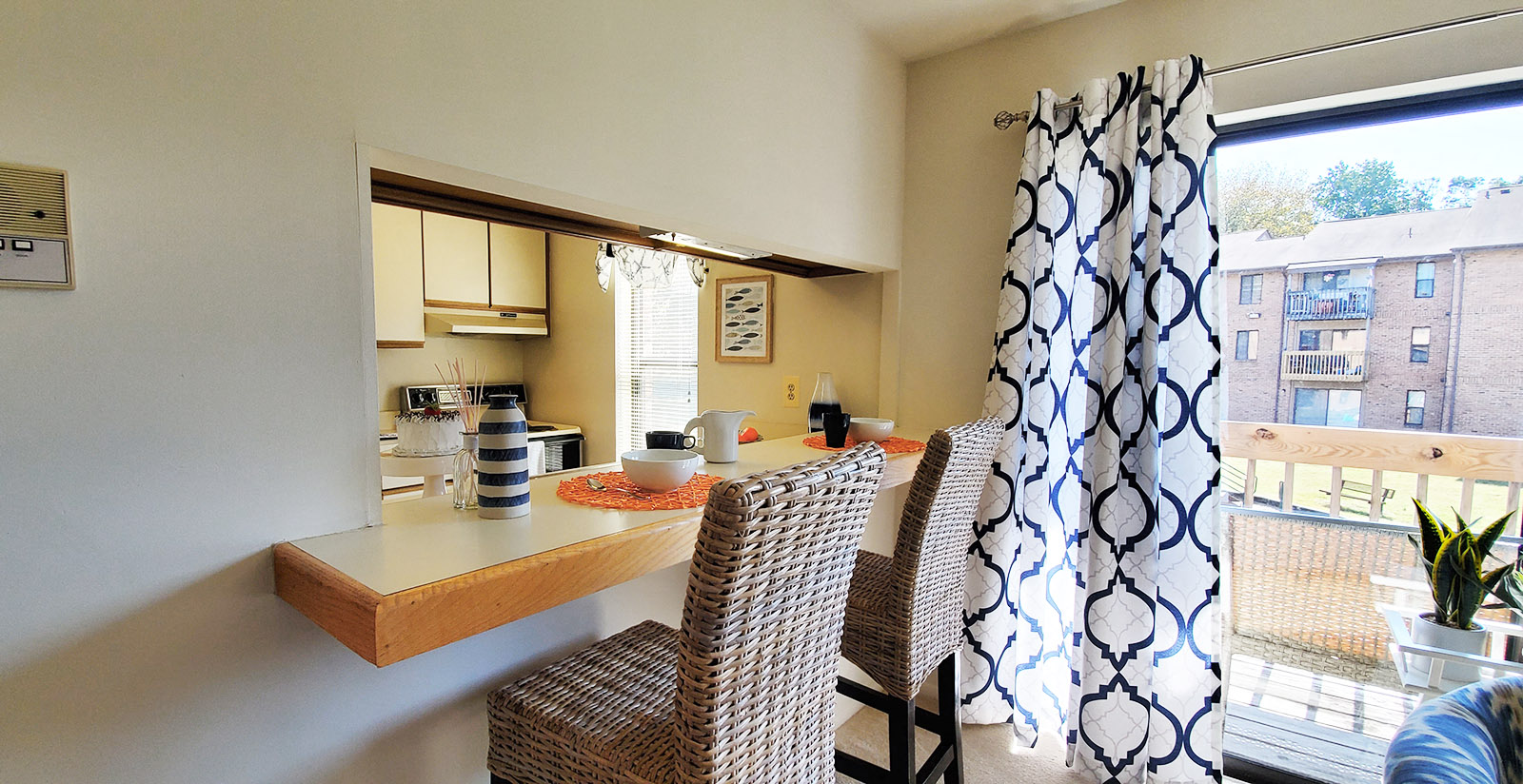 A kitchen with a table and chairs.