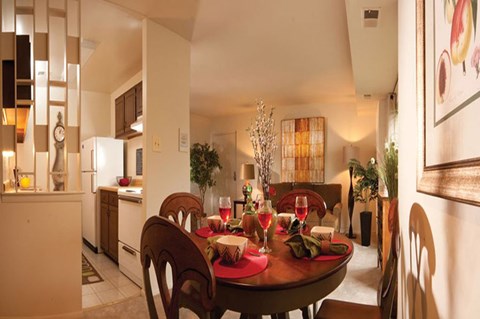 A dining room with a table set for a meal.
