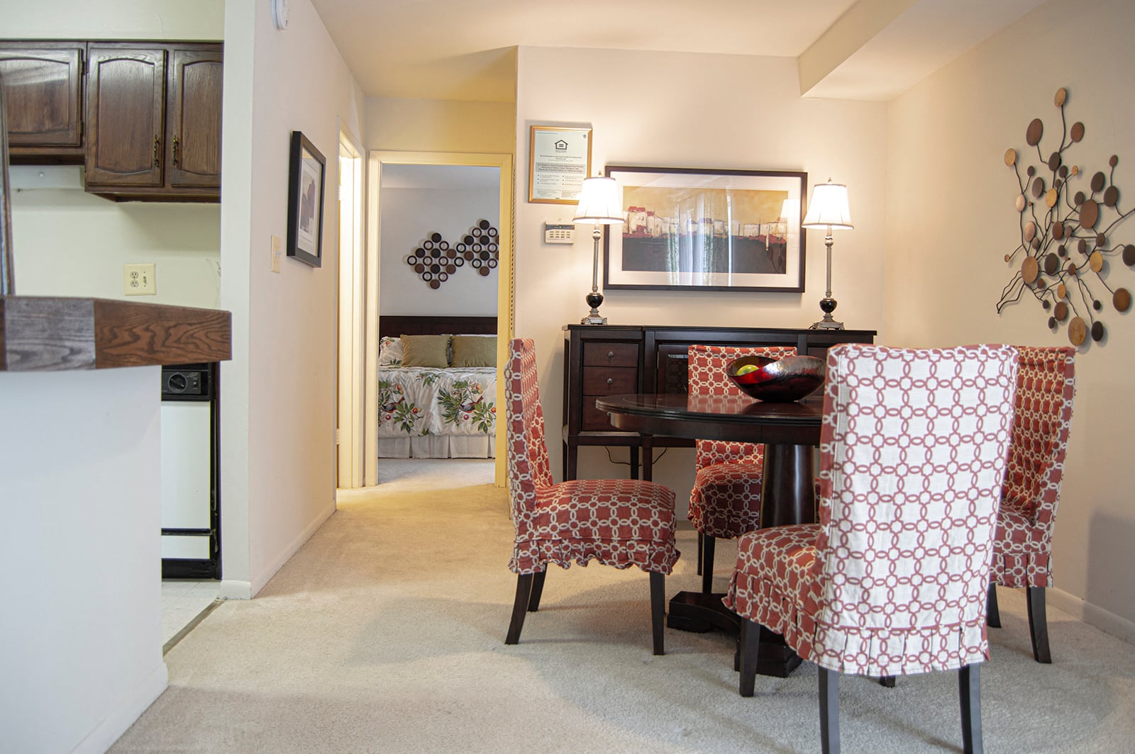 A dining room with a table and chairs.