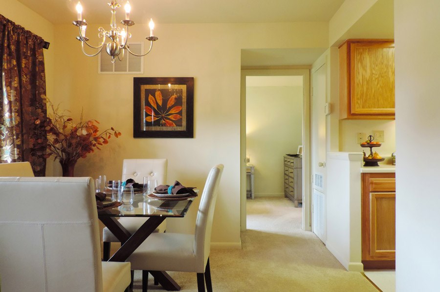 A dining room with a table set for two.
