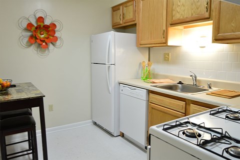 A kitchen with a white refrigerator and a white stove.