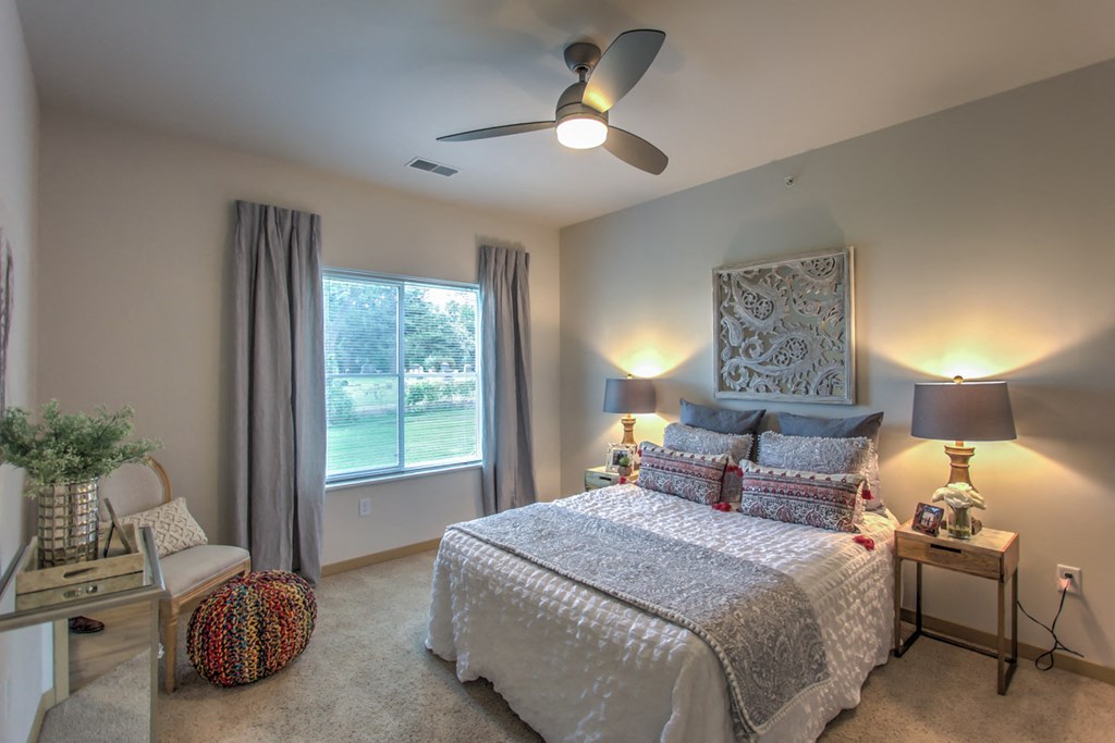 a bedroom with a bed and a ceiling fan