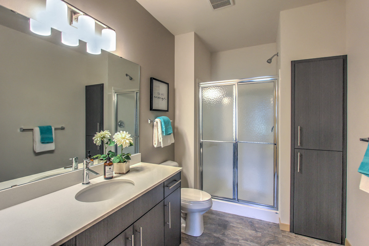 a bathroom with a sink and a shower and a toilet