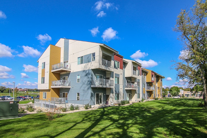 a row of apartments with balconies on a sunny day
