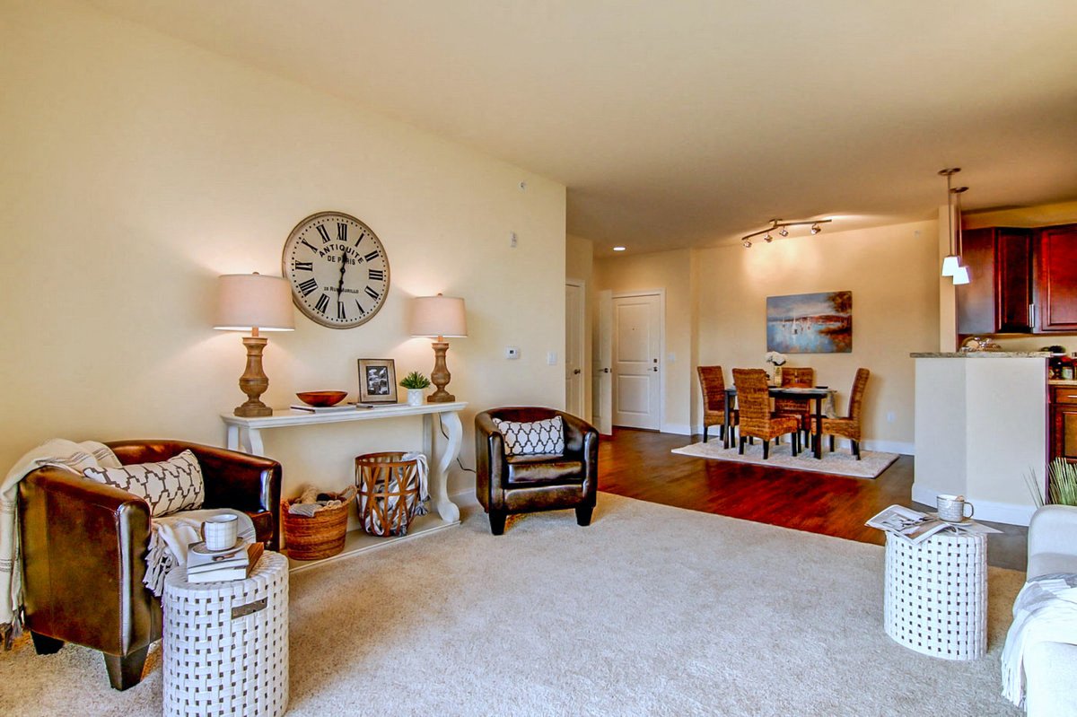 a living room with a large clock on the wall