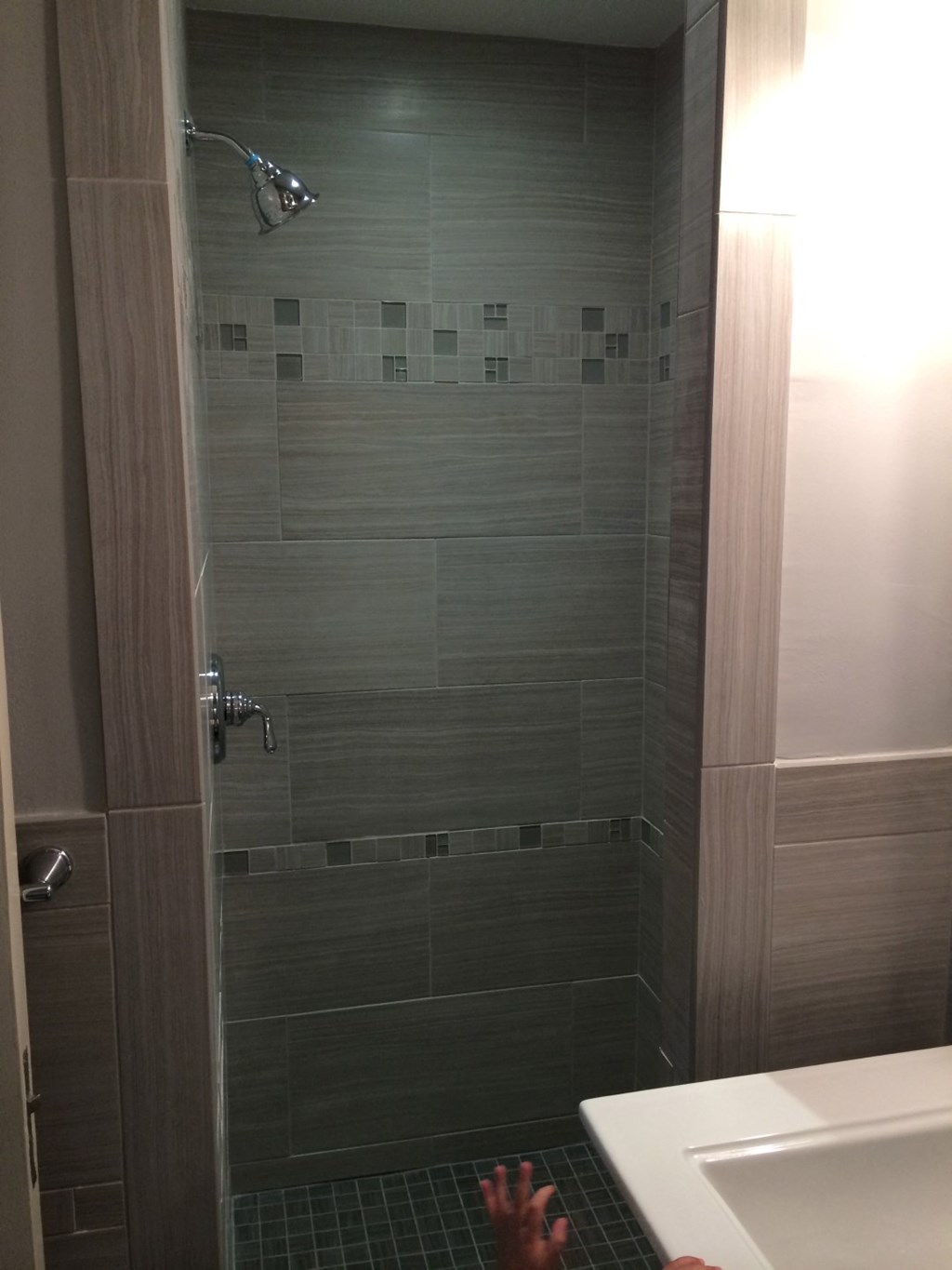 a bathroom with a shower and a sink