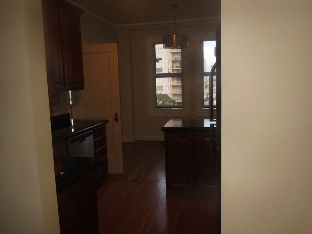 an empty kitchen with a window and a door