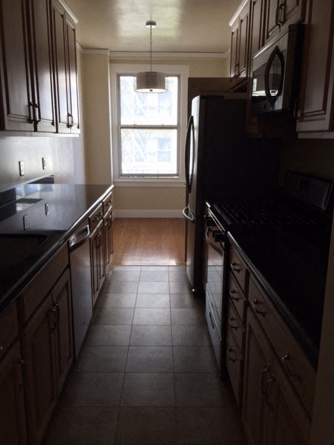 a kitchen with a stove and a window