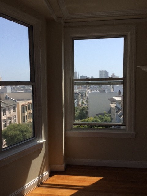 a view of the city from the window of a room