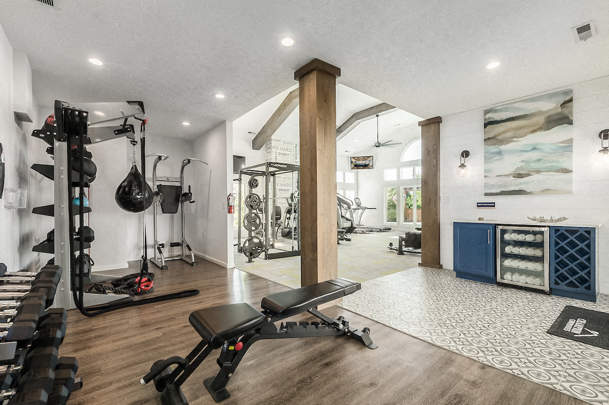 the gym has plenty of equipment and a large window