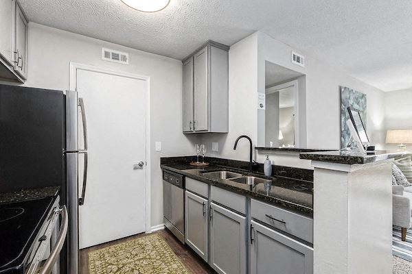 a kitchen with stainless steel appliances and a refrigerator